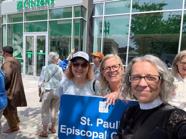 Members of St. Paul's Episcopal Church in Natick gather outside Citizens Bank.