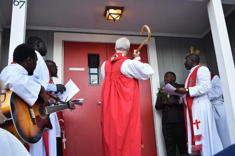 Bishop Alan Gates raps on African Mission Center doors at official opening