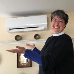 The Rev. Malia Crawford and the new heat pumps at the Church of Our Saviour